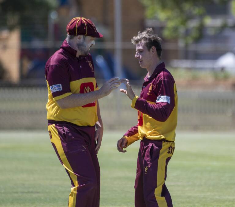 LET'S TALK TACTICS: Brad Smith chats with teenage quick Joey Mead at No 1 Oval on Saturday. Photo: Peter Hardin