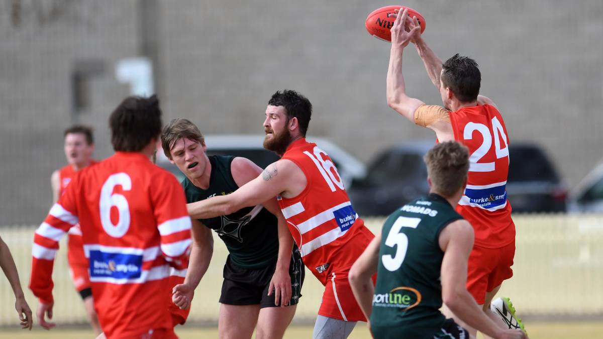 COLLISION IMMINENT: The Swans and the Nomads battle at No.1 Oval last year. The sides meet again in Tamworth on Saturday. 