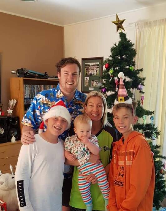 FAMILY TIES: City United captain Brad Smith with his wife, Amber, their son, Harlan, and his stepsons, Gabe (left) and John Harris. Photo: Supplied
