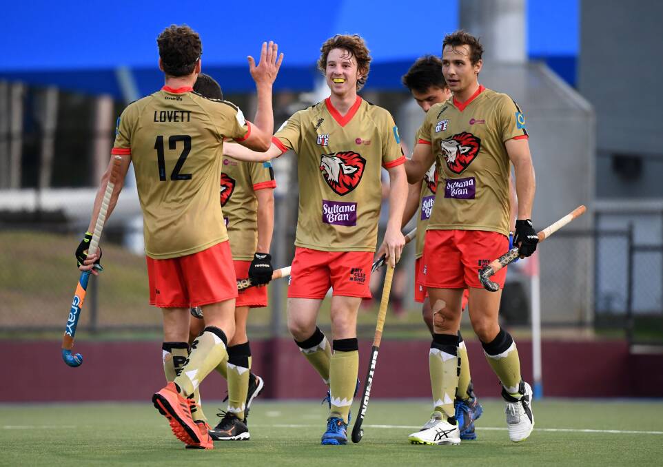 WELL OILED: Ehren Hazell's (centre) NSW Pride are into the inaugural Hockey One finale. Photo: AAP.
