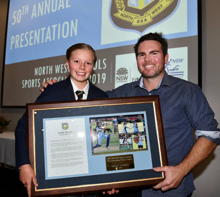 PROUD MOMENT: Sophie Parsons receives the most outstanding primary athlete award from former NRL star Jamie Lyon. Photo: Paul Mathews 