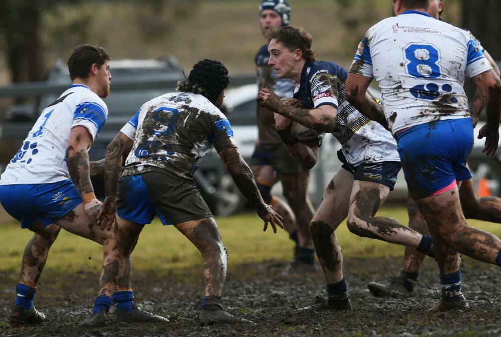 A SLOG: The Cowboys battle the Boars in the mud at Dungowan Recreation Reserve on July 24. Photo: Gareth Gardner 