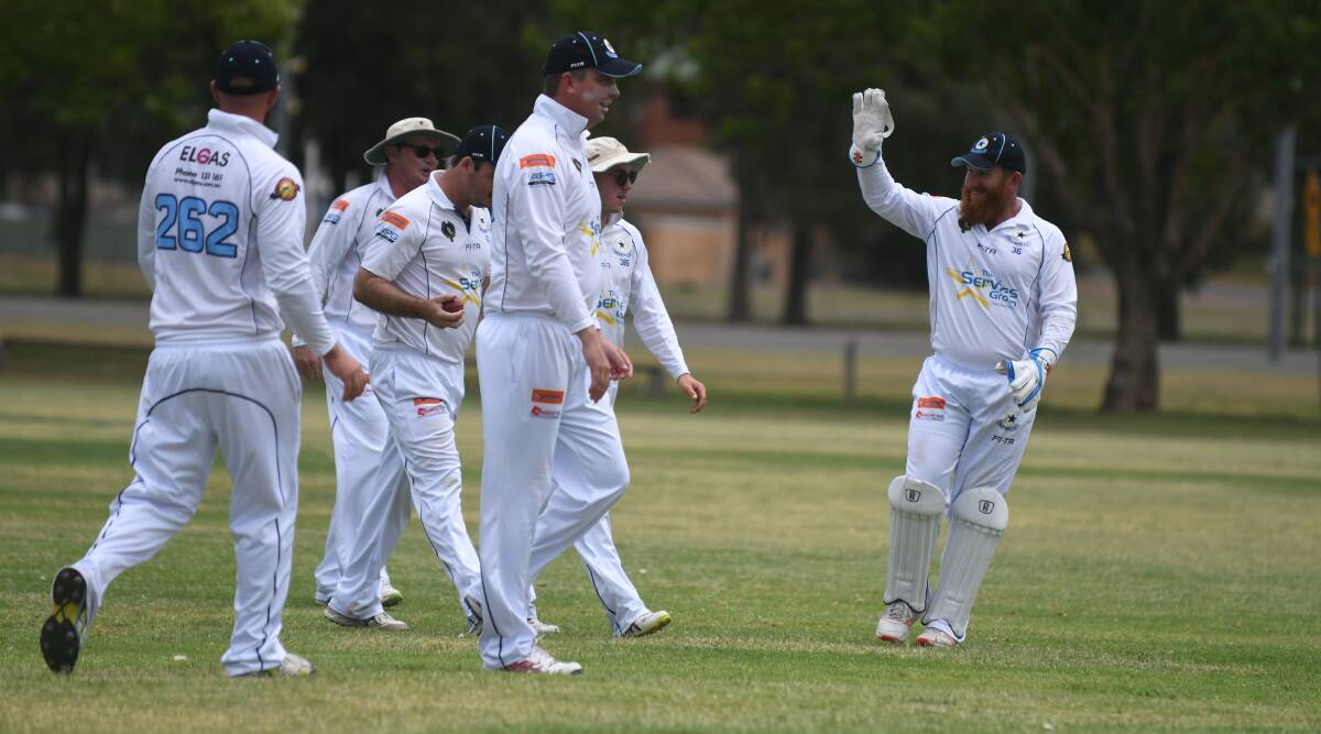 YEAH, BABY!: Old Boys keeper Simon Norvill and his teammates celebrate a Bulls wicket at Riverside 3 on Saturday.