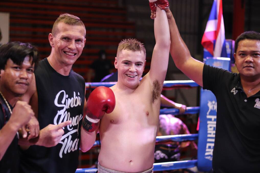 FORGED IN BATTLE: Tamworth teen Josh McCulloch and his trainer, Scott Chaffey, celebrate another Thai win. Photo: Facebook