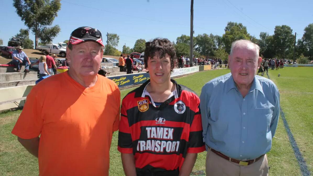 Tom with his father, Peter, and his grandfather at Jack Woolaston Oval in 2006. Picture by Robert Chappel