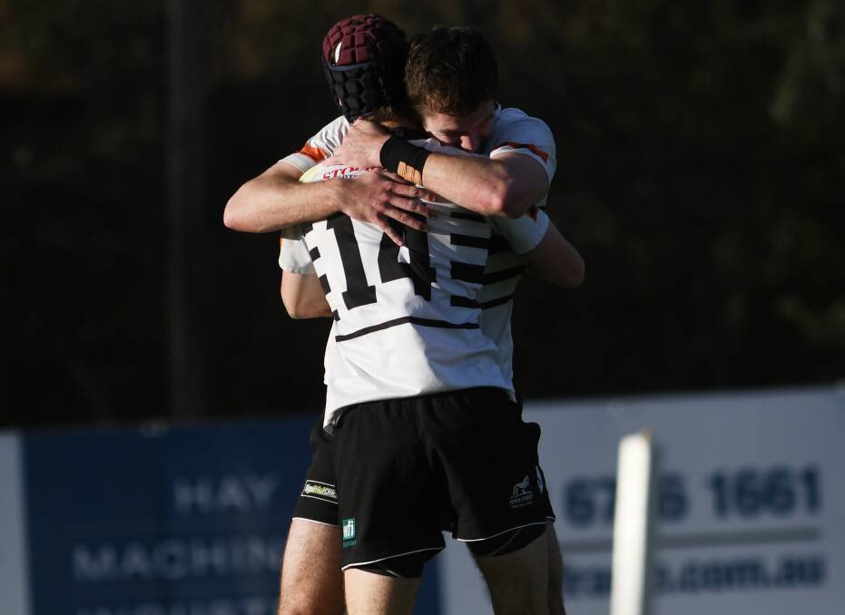 HOW SWEET IT IS: Snook celebrates one of his tries with Isaac Woodbury. Photo: Gareth Gardner 