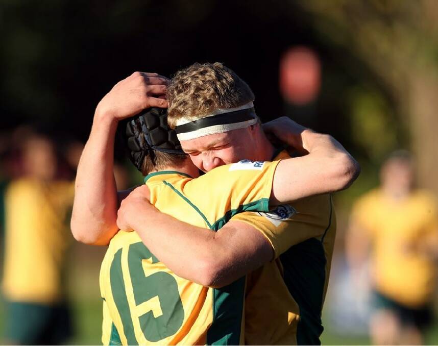 OH YEAH: Snook, wearing No.15, is congratulated by his skipper, Matthew Galvin, after Combined States' win over Victoria.