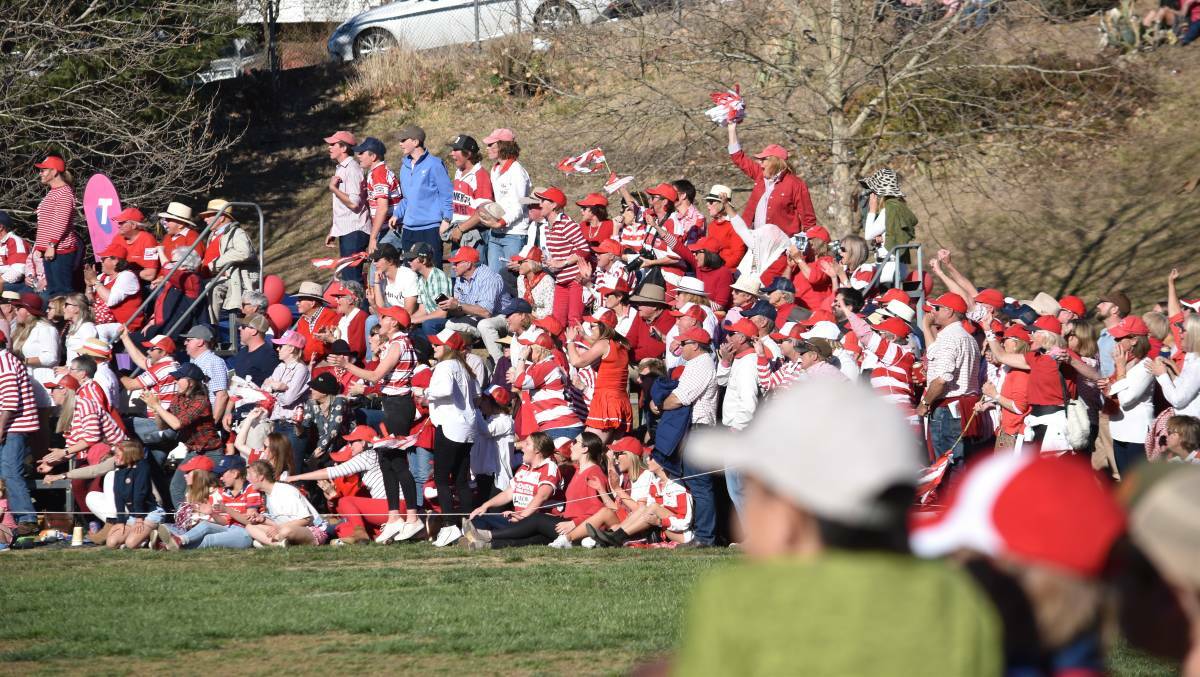 RED AND WHITE WAVE: Rams fans watch last Saturday's grand final between Walcha and Pirates. Photo: Ben Jaffrey 