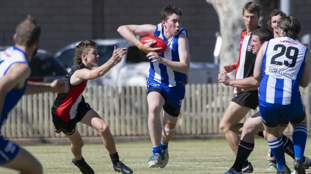 TEEN TALENT: Bill Tydd on the charge for the Roos at No 1 Oval in August. Photo: Peter Hardin