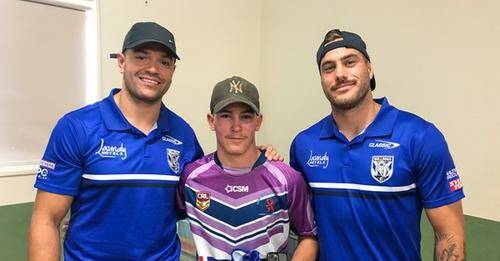 DOG LESSON: Canterbury players Braidon Burns (left) and Corey Allan with Kaleb Hope of Glen Innes. Photo: Supplied 