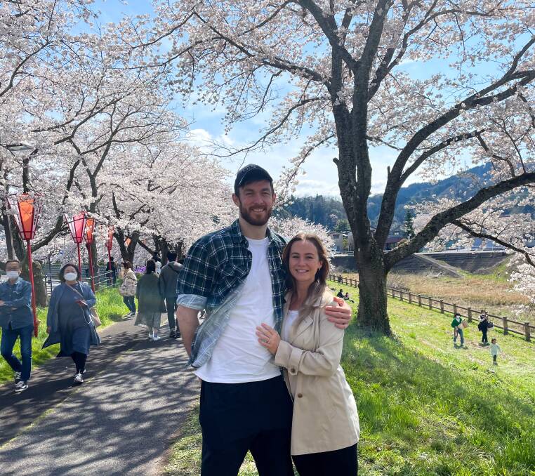 POSTCARD PERFECT: Nick Kay and Emily Tann amid the cherry blossoms at Matsue, his home during his basketball stint in Japan. Photo: Supplied