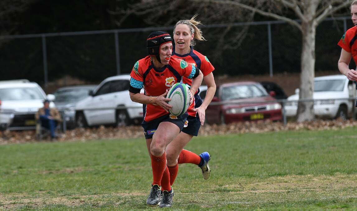 HUMMING MUM: Nichole Carlyon - Gunnedah's "mother duck" - is one of the side's most improved players this year, says Red Devils captain Sarah Stewart (in background). Photo: Sara Hincks 