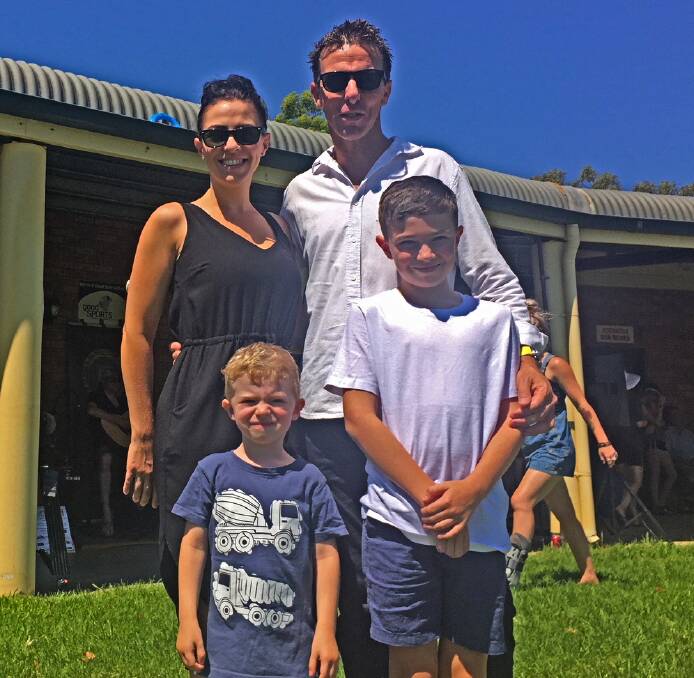 RETURN TO ROOTS: Retired motorcycle racer Warwick Nowland, a two-time Endurance world champion, with wife Kris and kids Aston, 9, and Ethan, 3, at Gunnedah Rugby Club.