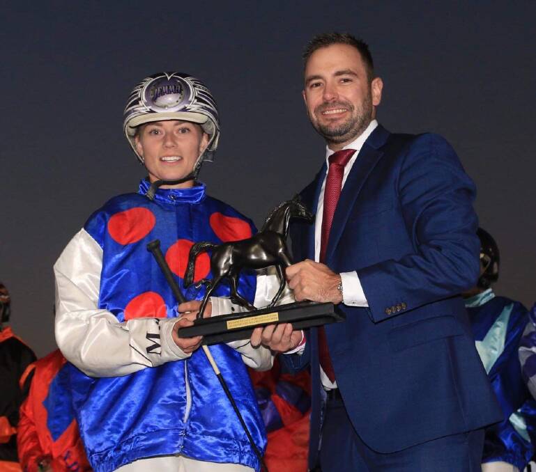 Great effort: Madi Young accepts her trophy from Lexus of Dubbo's Ben Johnson after guiding Soldtoyoulady to a $100/1 win at Bathurst.