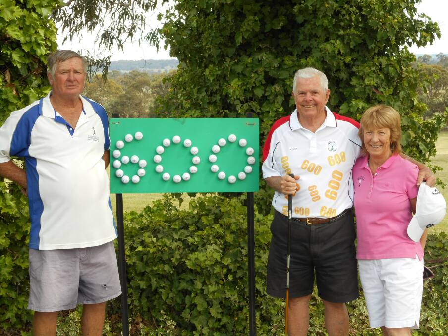 MAKING A MARK: Owen Presnell, John Sellwood and Julie Presnell with John's 600 board.