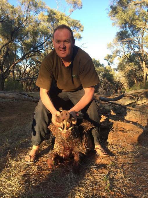 A picture from Shane Kember's Facebook page shows him posing with a wild boar.