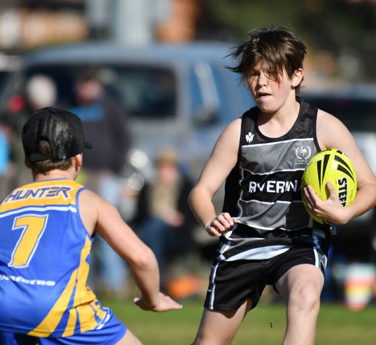 ON THE RUN: Riverina's Blayne Linsell takes on Hunter's Brandon Thompson during the NSW Primary Schools Sports Association Boys Touch Carnival in Tamworth this week. Photo: Barry Smith 260716BSB09