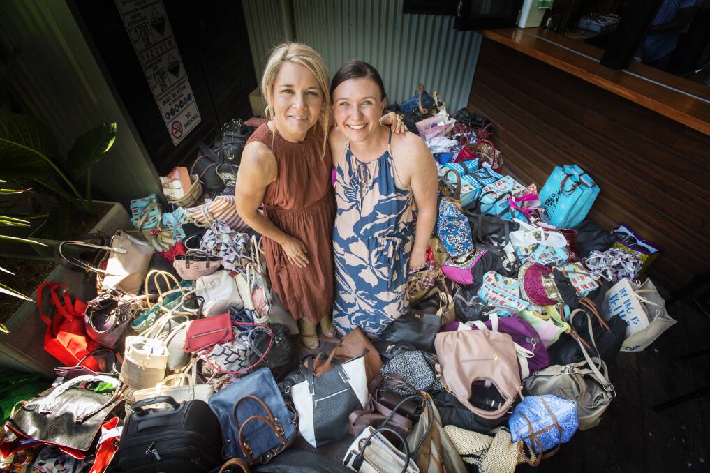 OVERWHELMING: 'It's in the bag' organisers Min McDonald and Kelly Eason with some of the 200 handbags filled with items to support women in need, all donated by local women. Photo: Peter Hardin 271116PHE036