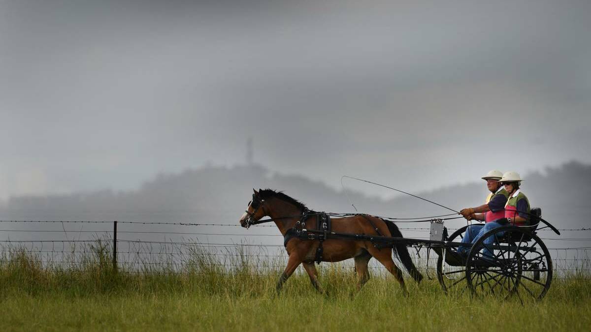 COOLING off: Col and Robyn Douglas from Kootingal enjoy a shower of rain. Photo: Stock image