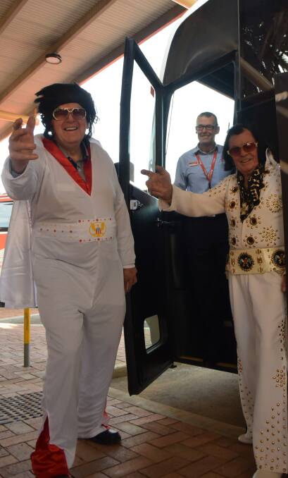 SHOW TIME: Elvis lovers Peter Bryan, Keith Ostler and John Caulfield welcome fans as they board a bus bound for Parkes Elvis Festival on Thursday morning. Photo: Ella Smith 