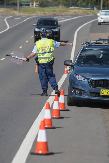 ON THE JOB: Highway patrol officers conduct roadside tests near Tamworth over the long weekend as part of Operation Tortoise. Photo: Peter Hardin 140417PHD034