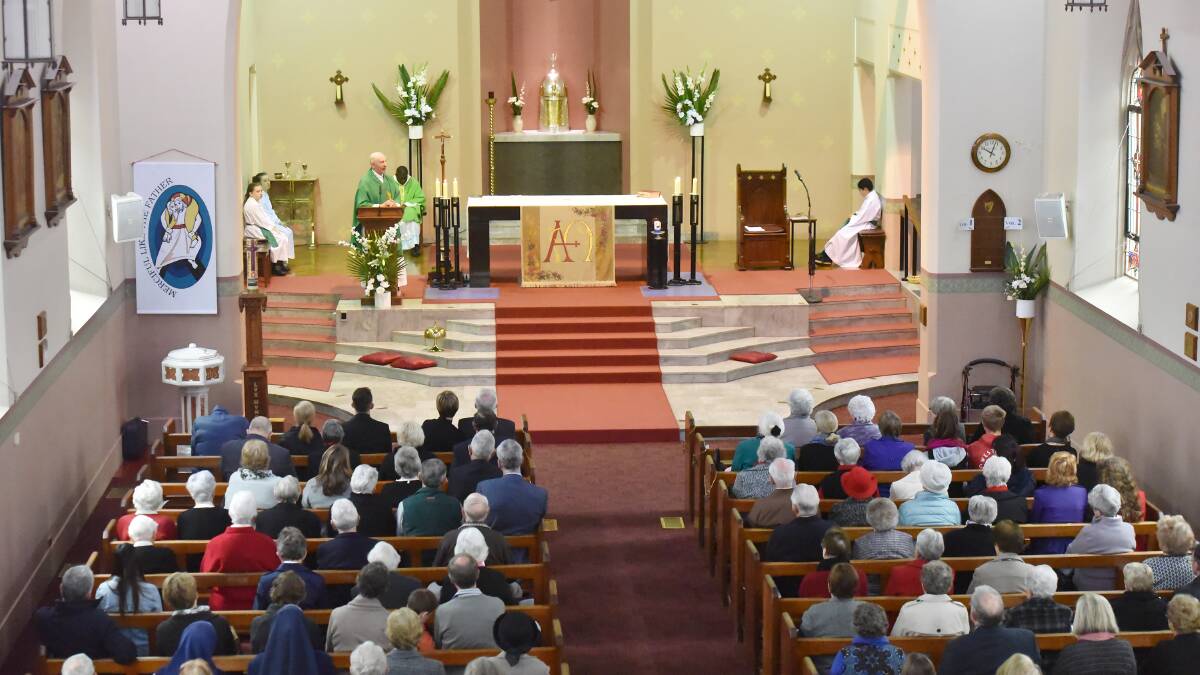 DIAMOND SERVICE: Father Tom Shanahan celebrates an incredible 60 years of serving as a priest with a packed congregation at St Nicholas Catholic Church on Sunday. Photo: Geoff O'Neill 
