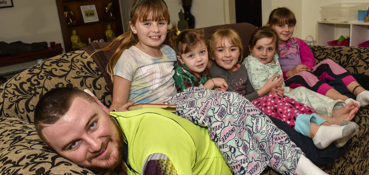 SPECIAL BOND: Tamworth father Josh Boobey with five of his six daughters loves everything about being a dad. Photo: Peter Hardin 020916PHC013