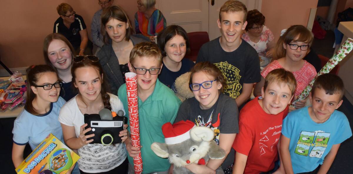 WRAPPED UP: Members of Oxley Vale Anglican Church Youth Group help wrap up donated gifts as part of Uniting Care Christmas Appeal to help local families.