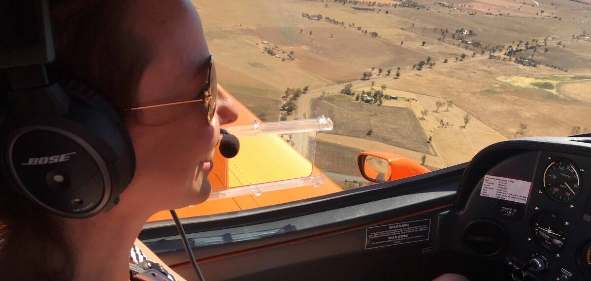 IN FLIGHT: Georgie Nichols takes the controls mid-flight during Gunnedah Aero Club's demonstration day. Photo: Contributed