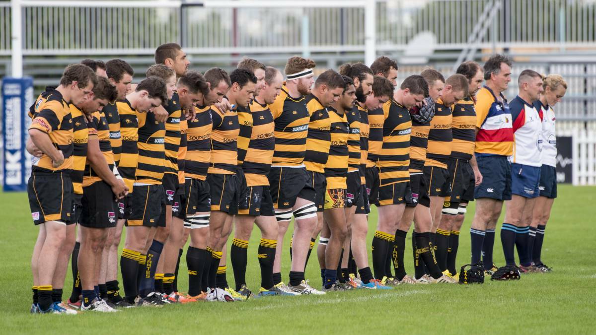 LOST BROTHER: The Pirates pause for a minutes silence to remember Jack Cutcliffe in their trial game against Balmain on Saturday. Photo: Peter Hardin