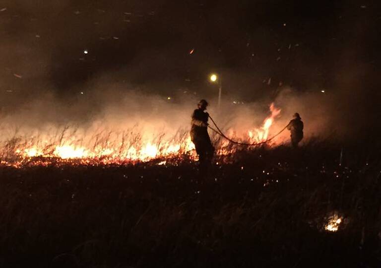 ON SCENE: Fire crews fight a West Tamworth fire on Sunday night.