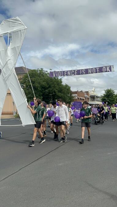 Macintrye High School students carry the white ribbon in the march. Picture supplied.