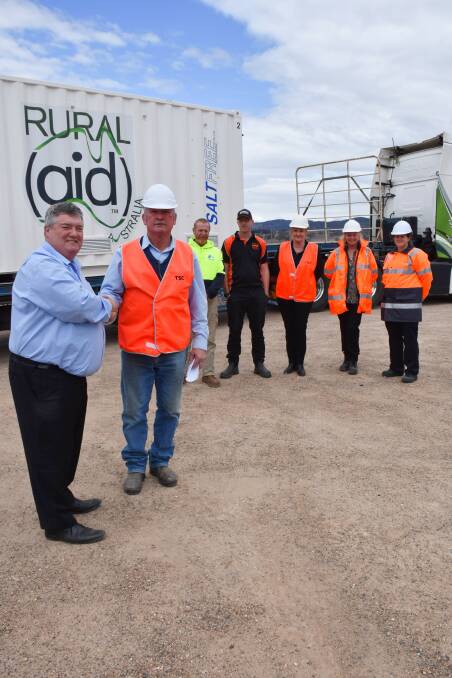 Rural Aid's Charles Alder hands over the aid organisation's first desalination plant to Mayor Peter Petty. Behind them are (from left) John McKinnie from Salt Free Desalination, driver Blair Johnston of Hancock Farming Enterprises, and council staff, Tamai Davidson, Gillian Marchant and Melissa Blum.
