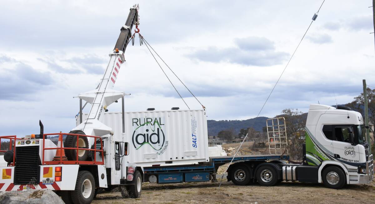 The council crane offloads the unit for installation on a pad near the water treatment plant at Tenterfield Dam.