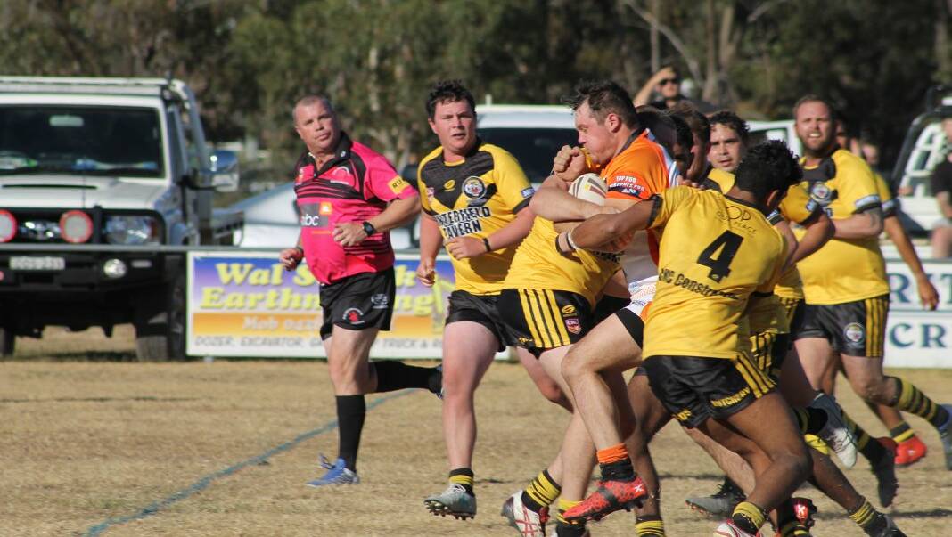 BIG CATS BATTLE: Uralla Tigers' Beau Hargraves puts a dent in the Tenterfield Tigers' defence. 