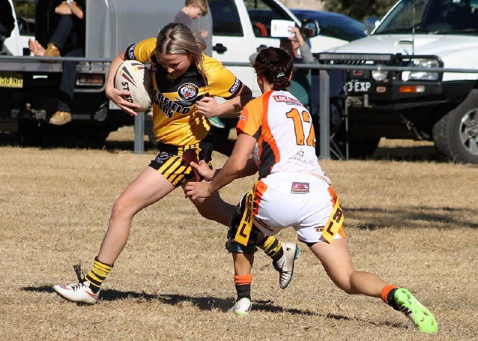IMPROVEMENT: Shay Landers is tagged by a Uralla defender in Saturday's loss to the ladder leaders. 