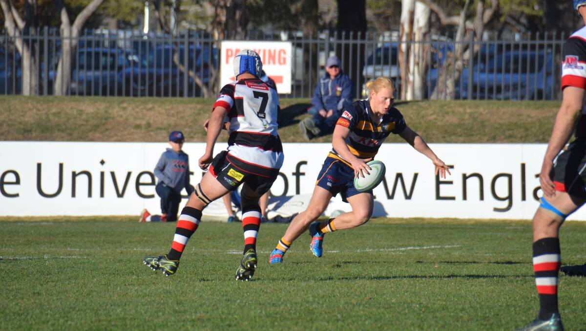 Armidale Blues half Kyson Henry gets a kick away in their semi-final win against the Barbarians on Saturday. 