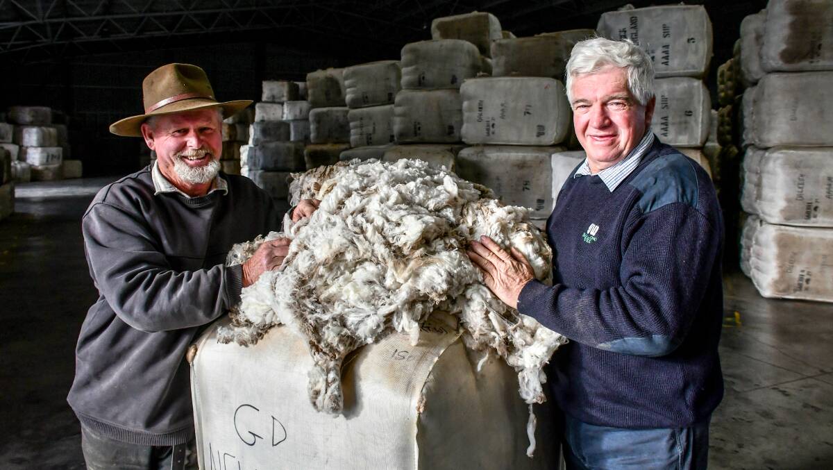 Tamworth wool grower Greg Drain with his broker, Tim Drury of Jemalong Wool (also on our cover). Mr Drain is storing his high-quality fleece lines and selling his lower-yielding wool. Photo: Lucy Kinbacher