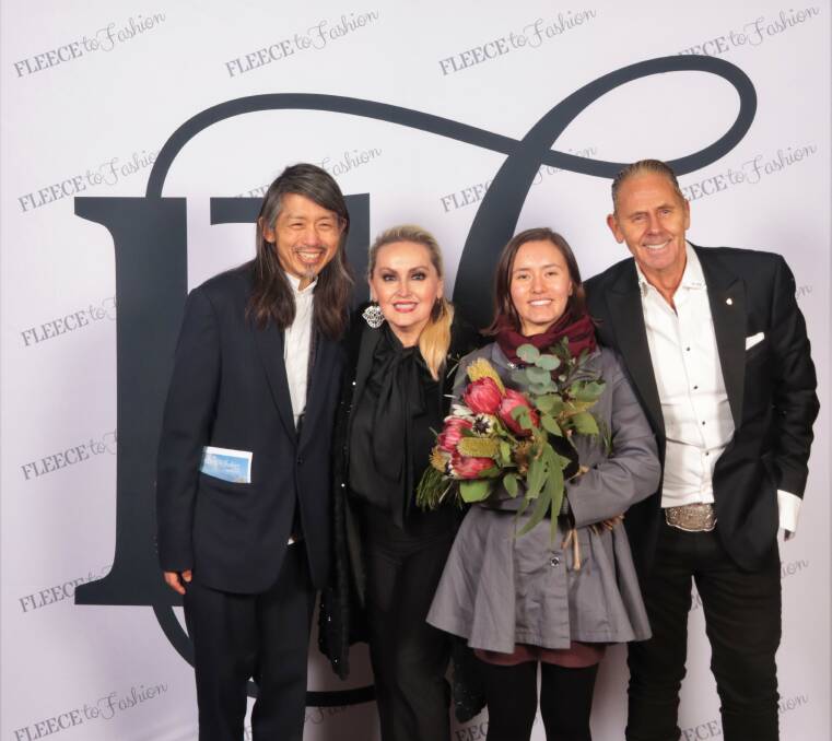 The 2022 Fleece to Fashion Supreme award winner and secondary school student Dechen K is flanked by judges, from left, Akira Isogawa, Melissa Hoyer and Jonathon Ward. 