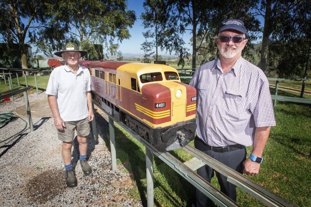CHUGGING ALONG: Tamworth and District Model Engineers' David Scott and Jim Booth with one of the miniature trains. Photo: Peter Hardin