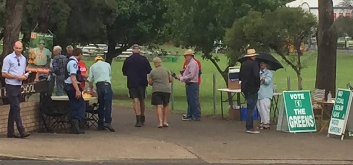 All quiet: Voters braved wet weather to vote at the Quirindi Secondary School after a shooting threat. Photograph: Juanita Greville