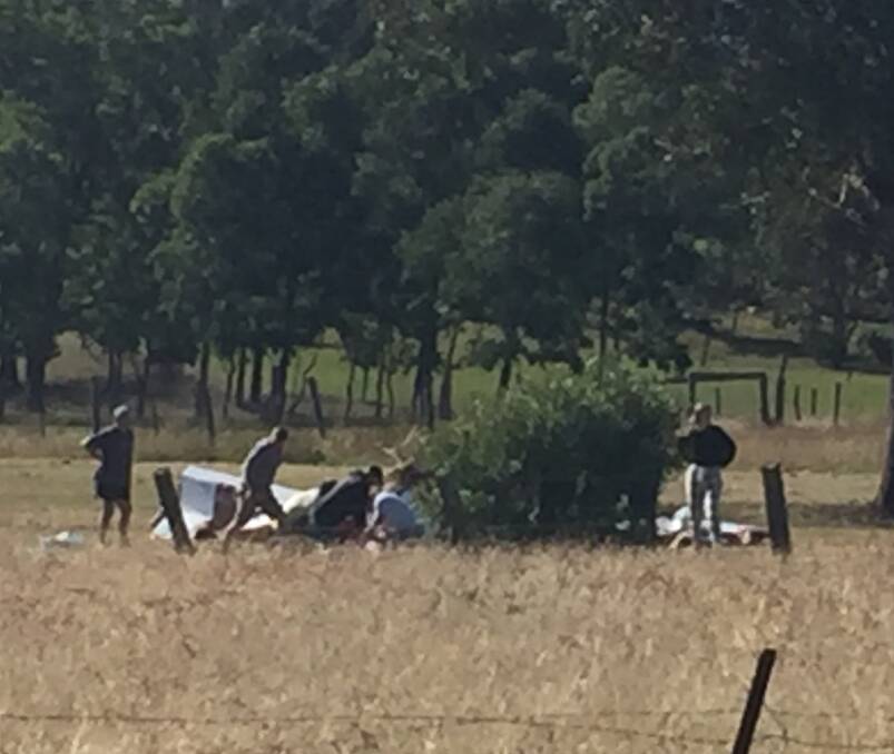 First responders: Residents rushed to the crash scene in an attempt to revive the pilot. Picture: Craig Kerry 