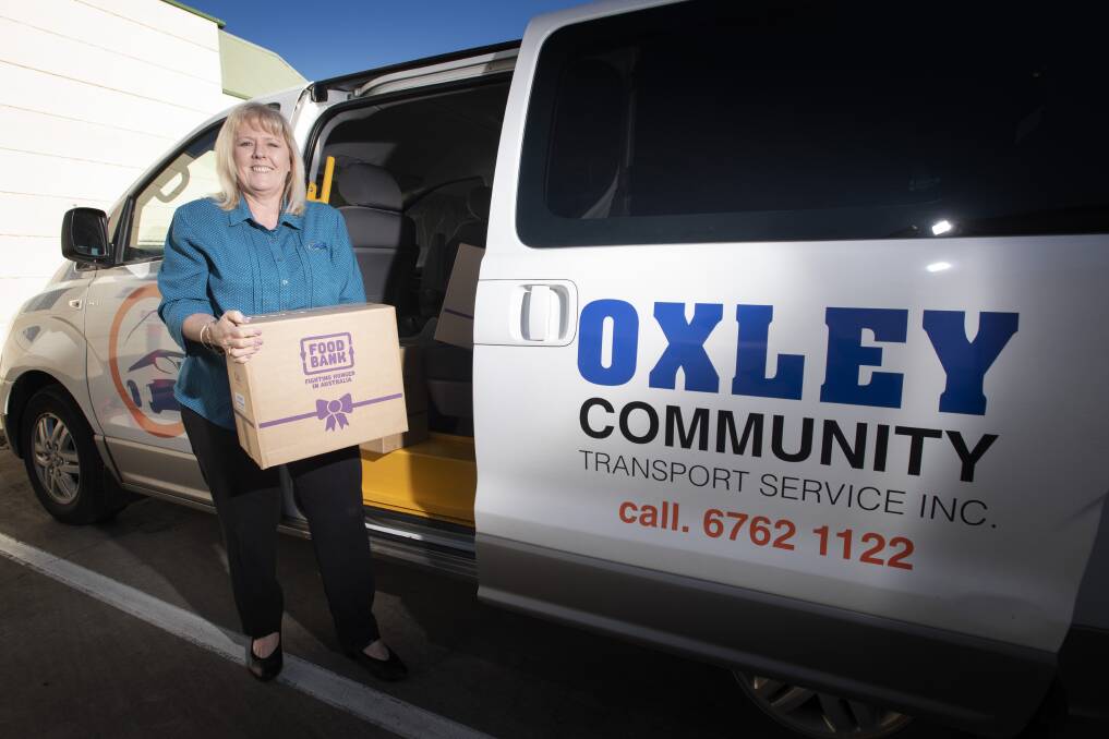 COUNTING DOWN: Kylie O'Leary helps pack food hampers to deliver to Oxley Community Transport clients after teaming up with Liberty Foodcare. Photo: Peter Hardin