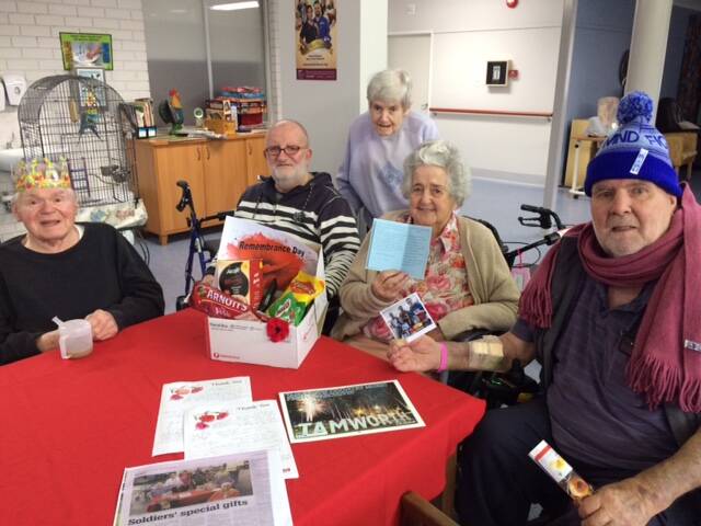 TREATS FOR TROOPS: Uniting McKay House nursing home residents Michael Ulcej, Reg Osborne, Jenny Swan, Patricia Wollaston and Eric Day with letters of thanks from soldiers who received care packages from them for Anzac Day. Photo: Supplied