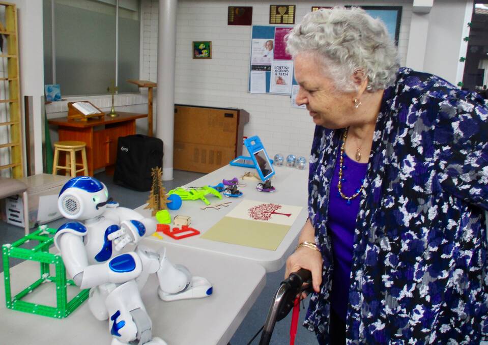 TECHNO TIME: Uniting McKay House resident Lynette Stirling with Cody the robot for Tamworth library's community engagement initiative. Photo: Sally Abra