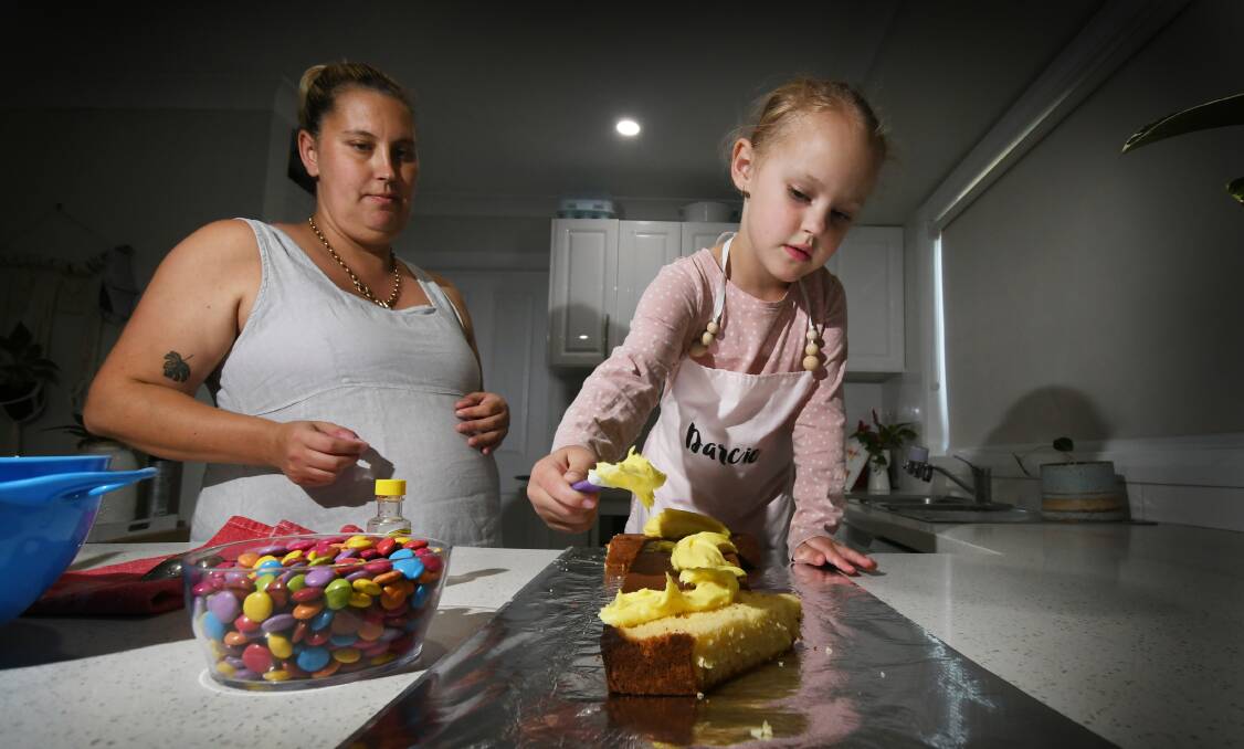FAMILY FUN: Jessie Smith and daughter Darcie decorate their cake. Photo: Gareth Gardner