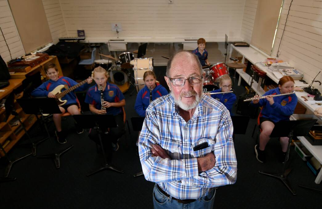 INSPIRED: Bill O'Neill has been a teacher for 59 years, and still turns up to work to help the kids learn music and play band - and order a pie at the canteen. Photo: Gareth Gardner