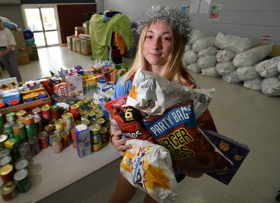 GIVING: Tamworth High School student Zoe Darlington with the huge haul of groceries that we donated on Friday. Photo: Gareth Gardner