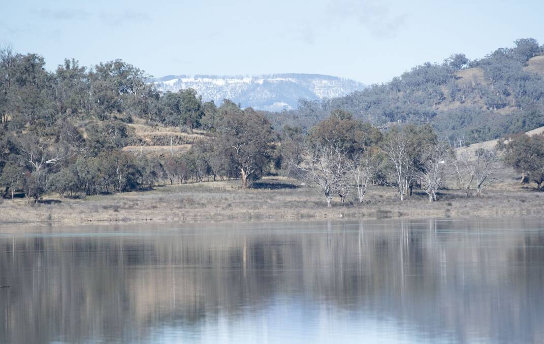 SNOW-CAPPED: The hills behind Chaffey Dam are covered in snow which will melt and boost the supply further. Photo: Peter Hardin