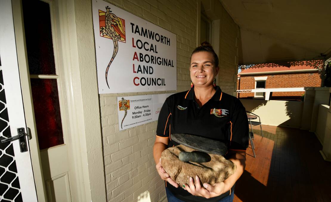 PRECIOUS: Tamworth Local Aboriginal Lands Council's Krystle Lamb, with the three Aboriginal artifacts after they were returned to Kamilaroi land. Photo: Gareth Gardner